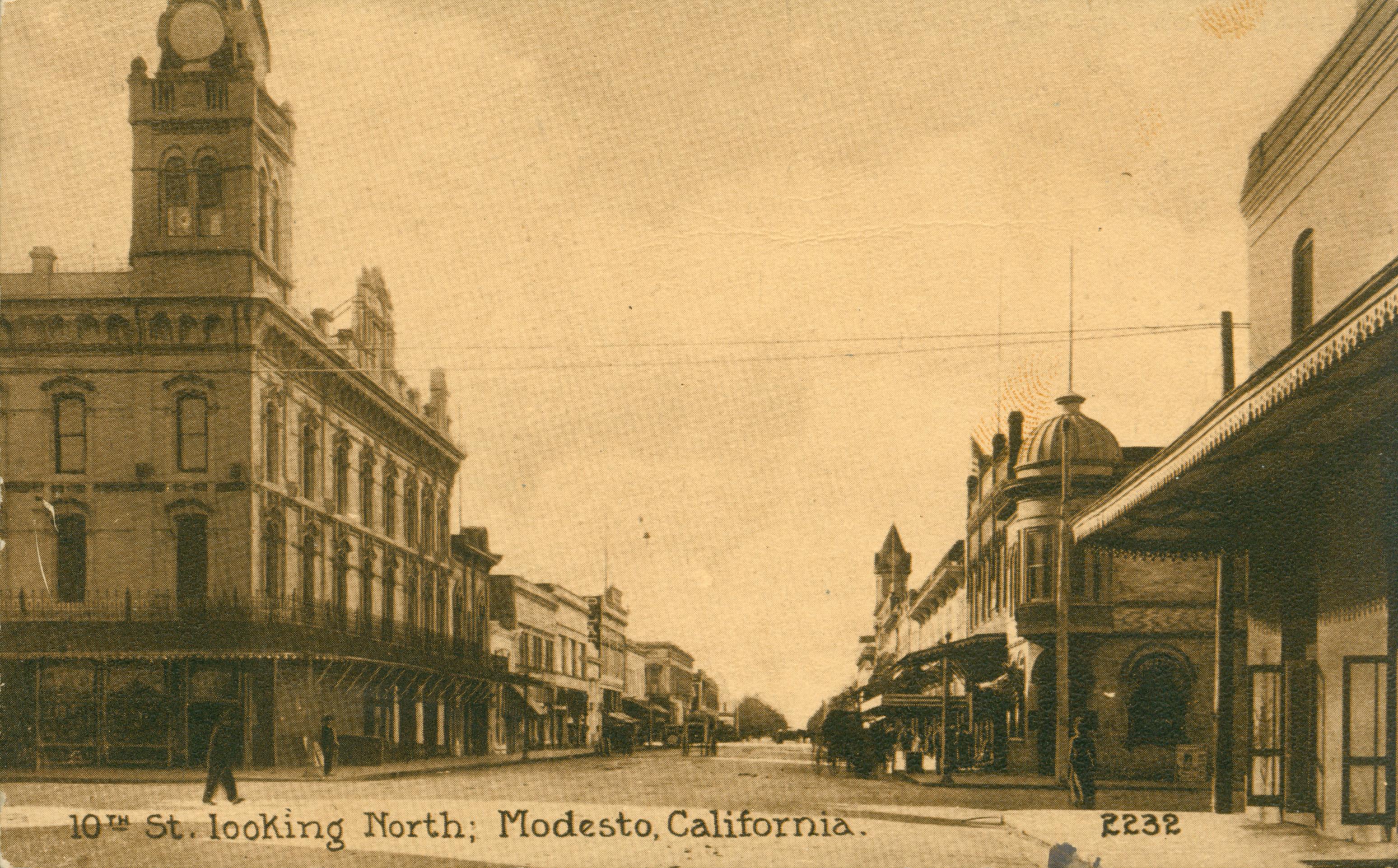 Shows Tenth Street in Modesto lined with buildings